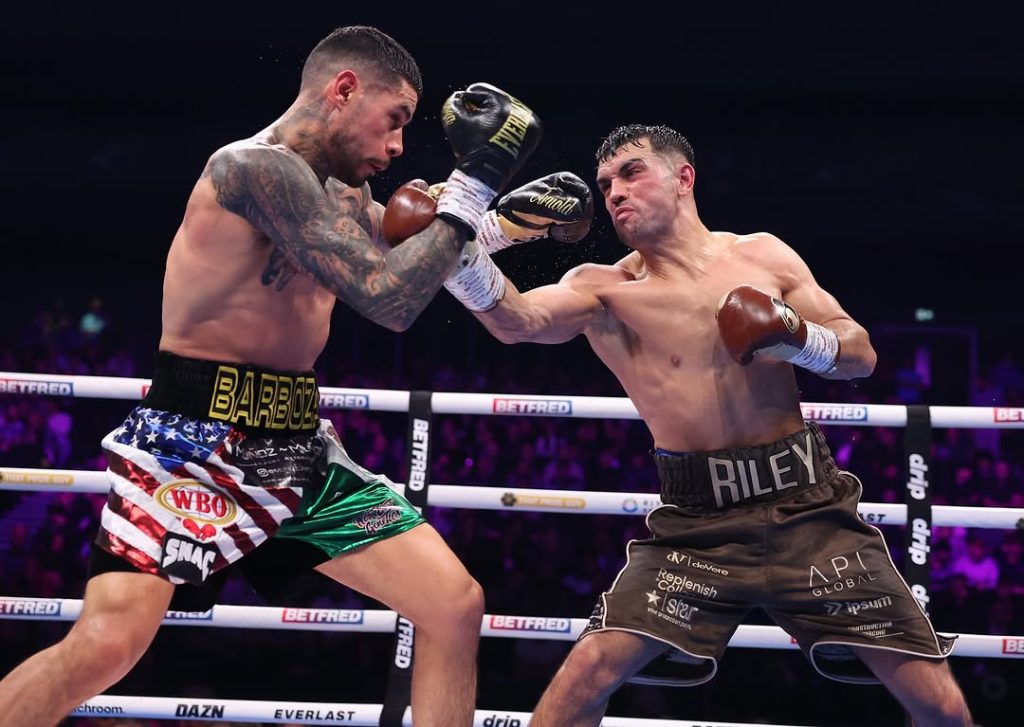 Jack Catterall y Arnold Barboza Jr. intercambian golpes durante su combate por el Mundial WBO Interino superligero